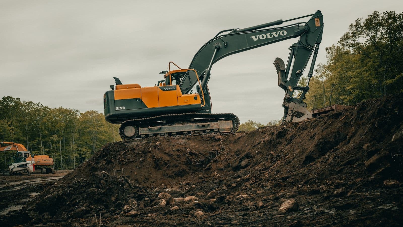 Excavator shaping earthworks for a below-ground stormwater detention installation