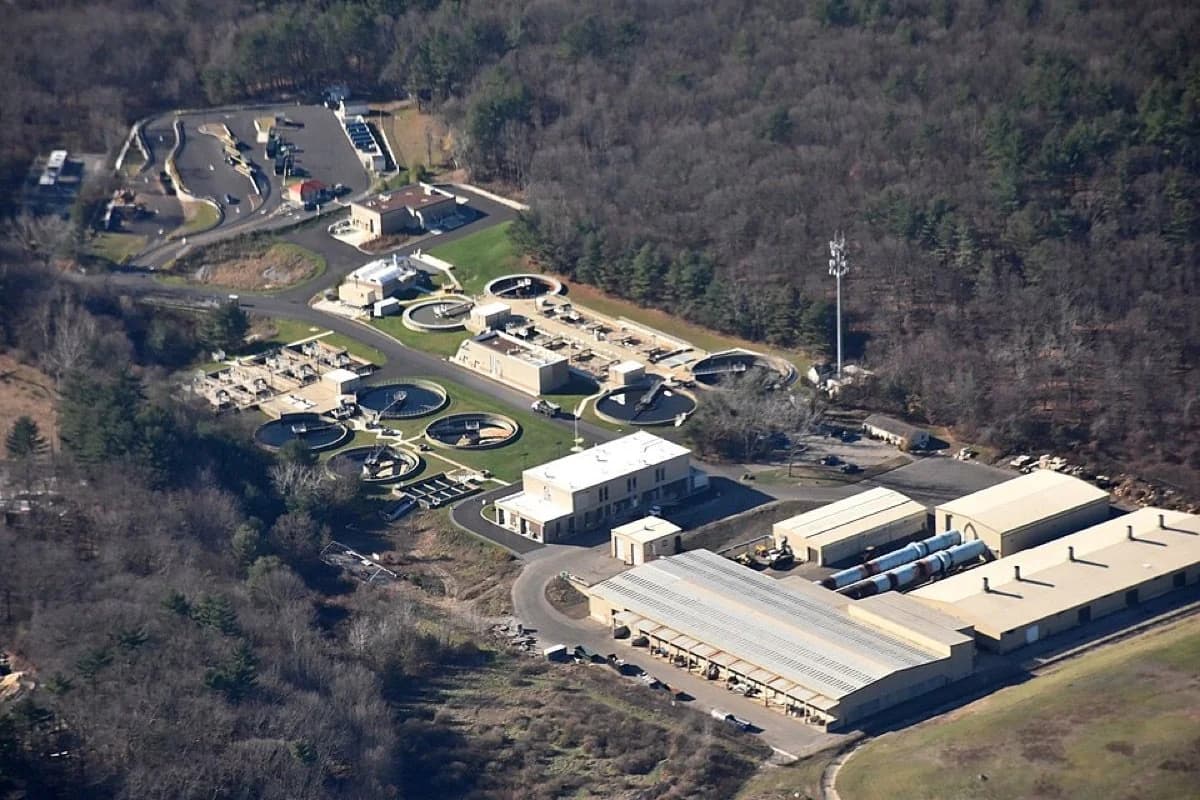 Aerial view of wastewater treatment plant with clarifiers and lagoons
